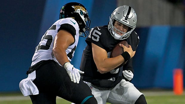 Jacksonville Jaguars linebacker Grant Morgan (55) sacks Las Vegas Raiders quarterback Chase Garbers (15) during the second half at Tom Benson Hall of Fame Stadium.